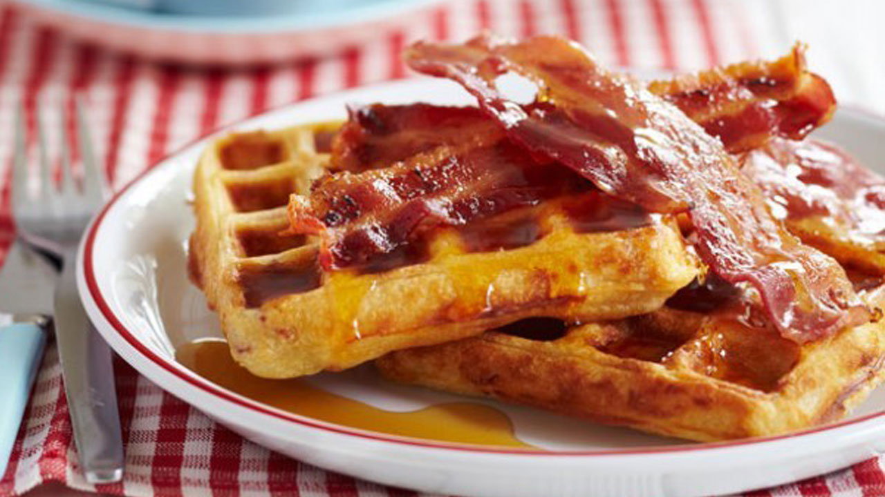 Potato and cheese waffles with crispy bacon and spiced maple syrup