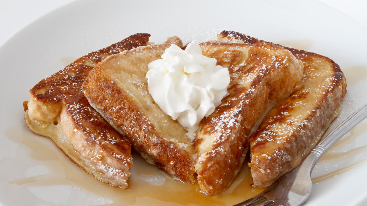 French toast with sticky toffee walnut sauce, served with whipped vanilla cream