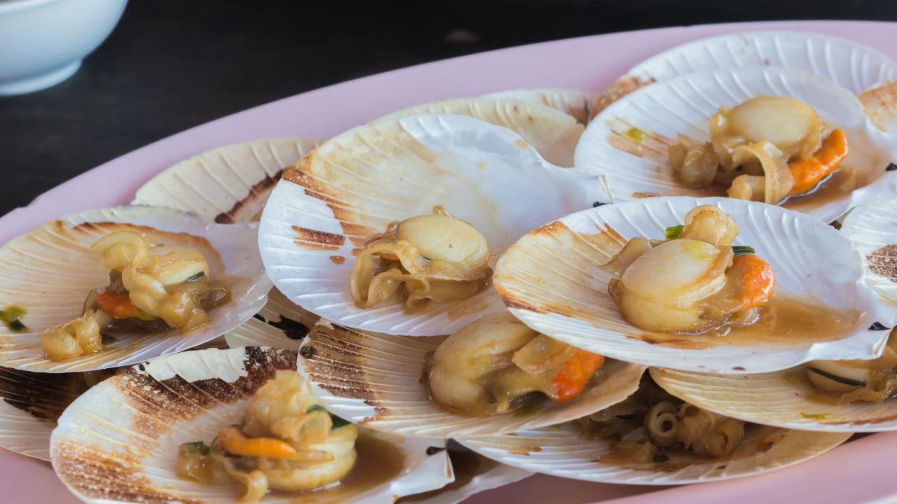 Baked scallops with hand picked crab, wild garlic mornay sauce, herb